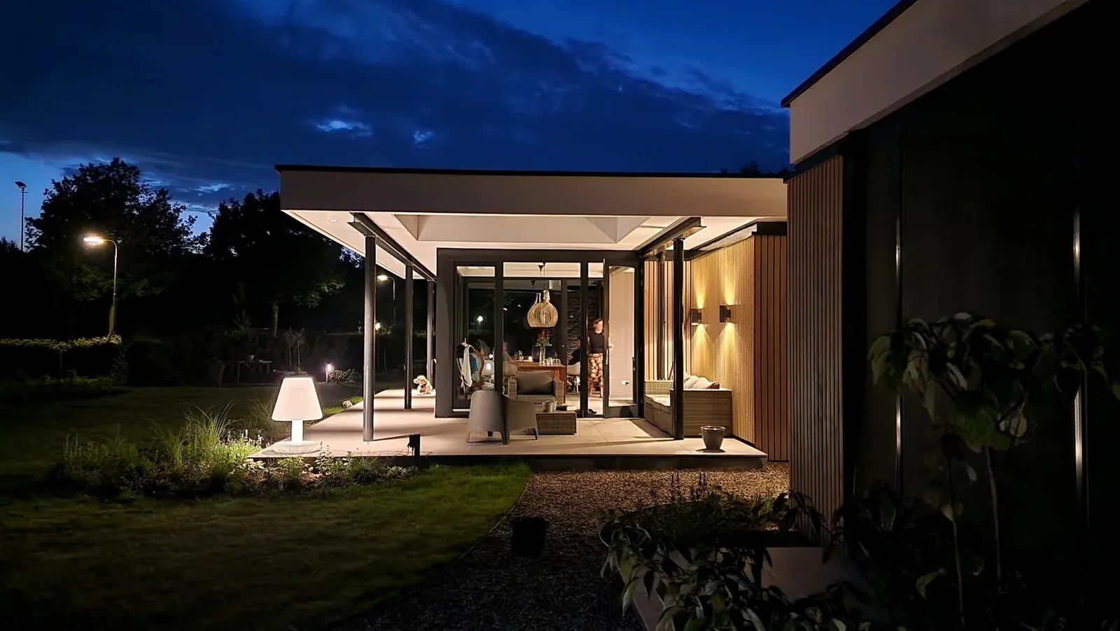 Compositie van gevel en overstek met sfeerverlichting binnen en buiten